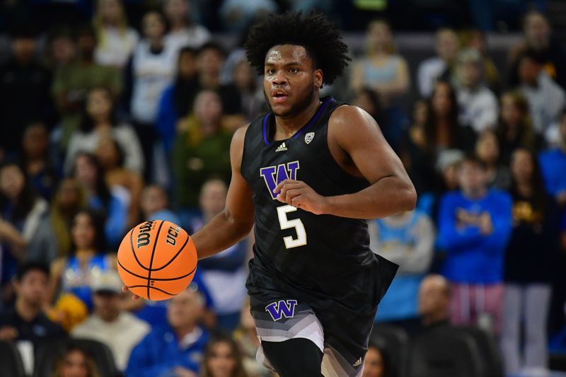 January 14, 2024; Los Angeles, California, USA; Washington Huskies guard Sahvir Wheeler (5) brings the ball up court against the UCLA Bruins during the first half at Pauley Pavilion. Mandatory Credit: Gary A. Vasquez-USA TODAY Sports