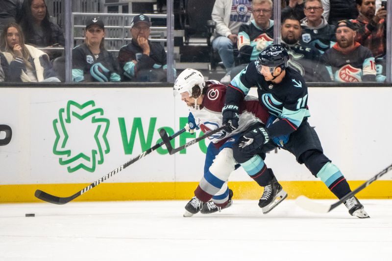 Oct 22, 2024; Seattle, Washington, USA;  Colorado Avalanche defenseman Samuel Girard (49) battles Seattle Kraken forward Jaden Schwartz (17) for the puck during the third period at Climate Pledge Arena. Mandatory Credit: Stephen Brashear-Imagn Images