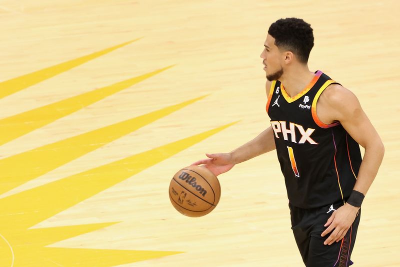 PHOENIX, ARIZONA - APRIL 18: Devin Booker #1 of the Phoenix Suns handles the ball during the first half of Game Two of the Western Conference First Round Playoffs against the LA Clippers at Footprint Center on April 18, 2023 in Phoenix, Arizona. The Suns defeated the Clippers 123-109. NOTE TO USER: User expressly acknowledges and agrees that, by downloading and or using this photograph, User is consenting to the terms and conditions of the Getty Images License Agreement.  (Photo by Christian Petersen/Getty Images)