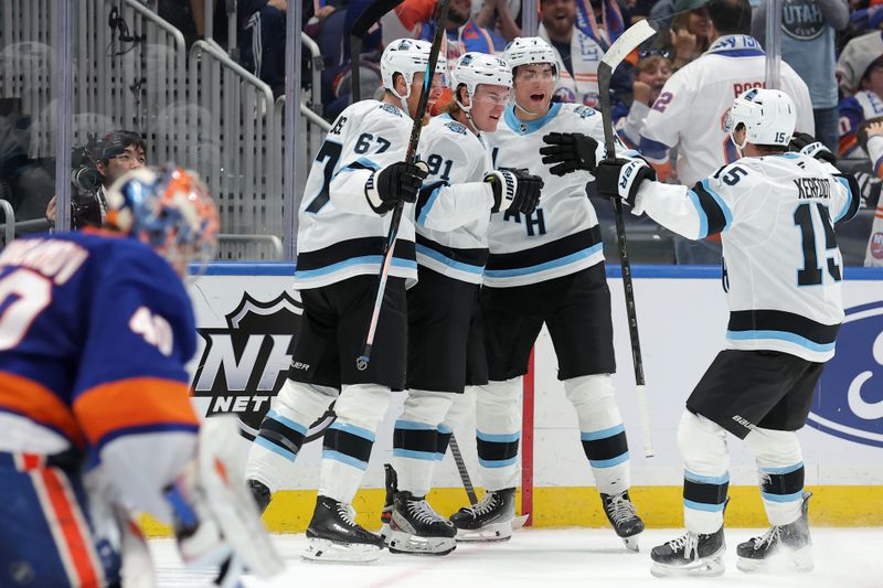 Oct 10, 2024; Elmont, New York, USA; Utah Hockey Club right wing Josh Doan (91) celebrates his goal against New York Islanders goaltender Semyon Varlamov (40) with teammates during the third period at UBS Arena. Mandatory Credit: Brad Penner-Imagn Images