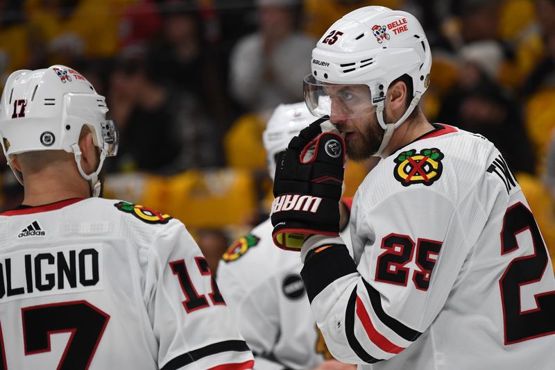 Jan 2, 2024; Nashville, Tennessee, USA; Chicago Blackhawks defenseman Jarred Tinordi (25) talks with left wing Nick Foligno (17) before a face off during the first period against the Nashville Predators at Bridgestone Arena. Mandatory Credit: Christopher Hanewinckel-USA TODAY Sports