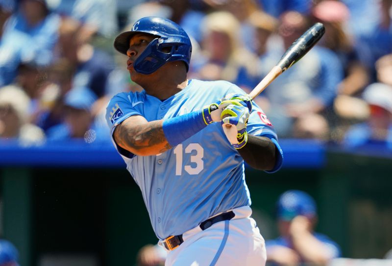 May 8, 2025; Kansas City, Missouri, USA; Kansas City Royals designated hitter Salvador Perez (13) hits an RBI double during the first inning against the Chicago White Sox at Kauffman Stadium. Mandatory Credit: Jay Biggerstaff-Imagn Images
