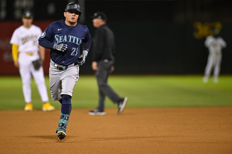 Sep 4, 2024; Oakland, California, USA; Seattle Mariners third baseman Luis Urías (23) runs the bases after his home run against the Oakland Athletics in the seventh inning at Oakland-Alameda County Coliseum. Mandatory Credit: Eakin Howard-Imagn Images