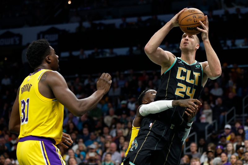 CHARLOTTE, NORTH CAROLINA - JANUARY 02: Mason Plumlee #24 of the Charlotte Hornets is fouled by Dennis Schroder #17 of the Los Angeles Lakers during the second quarter of the game at Spectrum Center on January 02, 2023 in Charlotte, North Carolina. NOTE TO USER: User expressly acknowledges and agrees that, by downloading and or using this photograph, User is consenting to the terms and conditions of the Getty Images License Agreement. (Photo by Jared C. Tilton/Getty Images)