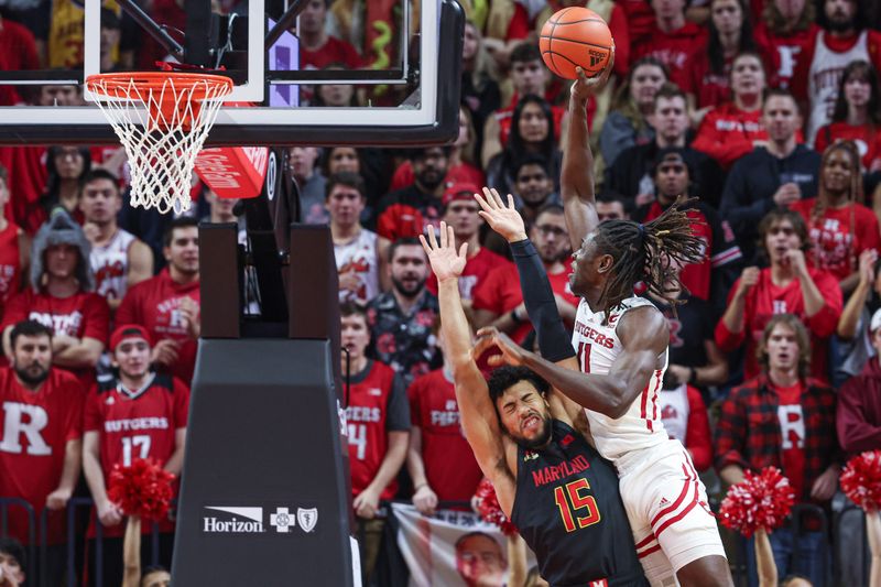 Jan 5, 2023; Piscataway, New Jersey, USA; Rutgers Scarlet Knights center Clifford Omoruyi (11) is fouled by Maryland Terrapins forward Patrick Emilien (15) while driving to the basket during the first half at Jersey Mike's Arena. Mandatory Credit: Vincent Carchietta-USA TODAY Sports