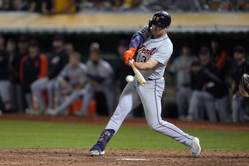 Sep 6, 2024; Oakland, California, USA; Detroit Tigers second baseman Colt Keith (33) hits an RBI single against the Oakland Athletics during the tenth inning at Oakland-Alameda County Coliseum. Mandatory Credit: Darren Yamashita-Imagn Images