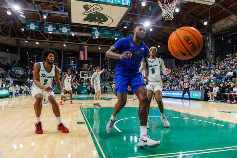 Jan 30, 2025; New Orleans, Louisiana, USA;  Memphis Tigers forward Dain Dainja (42) looses the ball against Tulane Green Wave forward Tyler Ringgold (0) during the first half at Avron B. Fogelman Arena in Devlin Fieldhouse. Mandatory Credit: Stephen Lew-Imagn Images