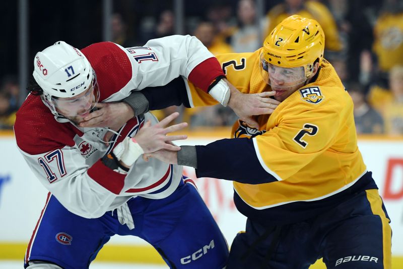 Mar 5, 2024; Nashville, Tennessee, USA; Montreal Canadiens right wing Josh Anderson (17) and Nashville Predators defenseman Luke Schenn (2) fight during the second period at Bridgestone Arena. Mandatory Credit: Christopher Hanewinckel-USA TODAY Sports