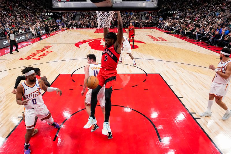 TORONTO, ON - NOVEMBER 29: Precious Achiuwa #5 of the Toronto Raptors dunks against the Phoenix Suns during first half action at the Scotiabank Arena on November 29, 2023 in Toronto, Ontario, Canada. NOTE TO USER: User expressly acknowledges and agrees that, by downloading and/or using this Photograph, user is consenting to the terms and conditions of the Getty Images License Agreement. (Photo by Andrew Lahodynskyj/Getty Images)