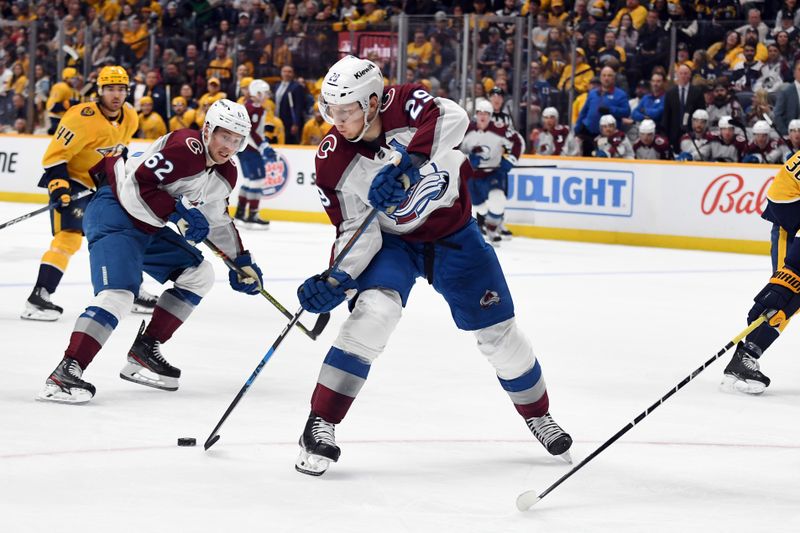 Mar 2, 2024; Nashville, Tennessee, USA; Colorado Avalanche center Nathan MacKinnon (29) passes the puck to left wing Artturi Lehkonen (62) during the second period against the Nashville Predators at Bridgestone Arena. Mandatory Credit: Christopher Hanewinckel-USA TODAY Sports