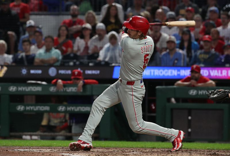Jun 6, 2025; Pittsburgh, Pennsylvania, USA;  Philadelphia Phillies second baseman Bryson Stott (5) hits a single against the Pittsburgh Pirates during the fourth inning at PNC Park. Mandatory Credit: Charles LeClaire-Imagn Images
