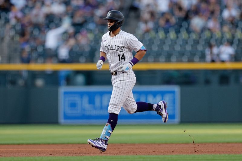 Aug 27, 2024; Denver, Colorado, USA; Colorado Rockies shortstop Ezequiel Tovar (14) rounds the bases on a solo home run in the first inning against the Miami Marlins at Coors Field. Mandatory Credit: Isaiah J. Downing-USA TODAY Sports