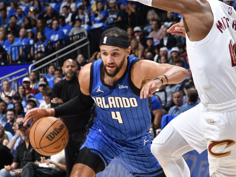 ORLANDO, FL - APRIL 27: Jalen Suggs #4 of the Orlando Magic dribbles the ball during the game against the Cleveland Cavaliers during Round 1 Game 4 of the 2024 NBA Playoffs on April 27, 2024 at the Kia Center in Orlando, Florida. NOTE TO USER: User expressly acknowledges and agrees that, by downloading and or using this photograph, User is consenting to the terms and conditions of the Getty Images License Agreement. Mandatory Copyright Notice: Copyright 2024 NBAE (Photo by Fernando Medina/NBAE via Getty Images)