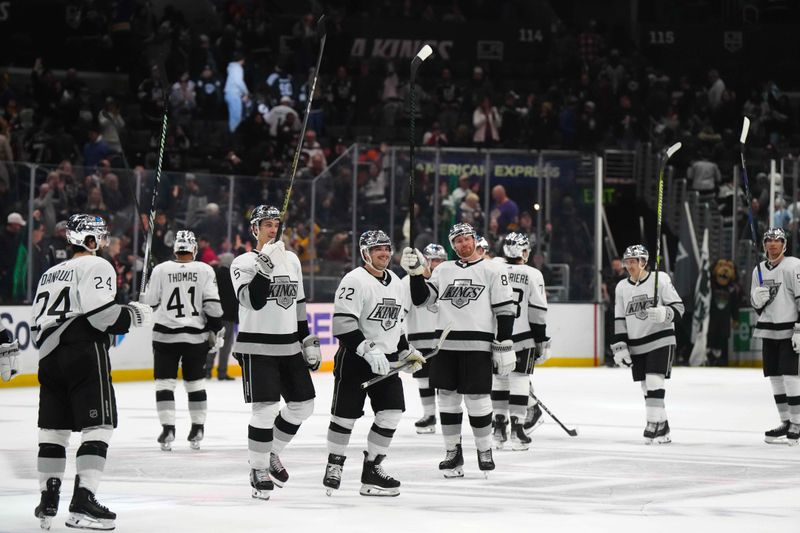 Apr 13, 2024; Los Angeles, California, USA; LA Kings center Phillip Danault (24), defenseman Andreas Englund (5), left wing Kevin Fiala (22) and defenseman Vladislav Gavrikov (84) celebrate after the game against the Anaheim Ducks at Crypto.com Arena. Mandatory Credit: Kirby Lee-USA TODAY Sports