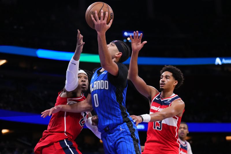 ORLANDO, FLORIDA - FEBRUARY 23: Anthony Black #0 of the Orlando Magic goes up for a shot against Richaun Holmes #22 of the Washington Wizards during the fourth quarter at Kia Center on February 23, 2025 in Orlando, Florida. NOTE TO USER: User expressly acknowledges and agrees that, by downloading and or using this photograph, User is consenting to the terms and conditions of the Getty Images License Agreement. (Photo by Rich Storry/Getty Images)