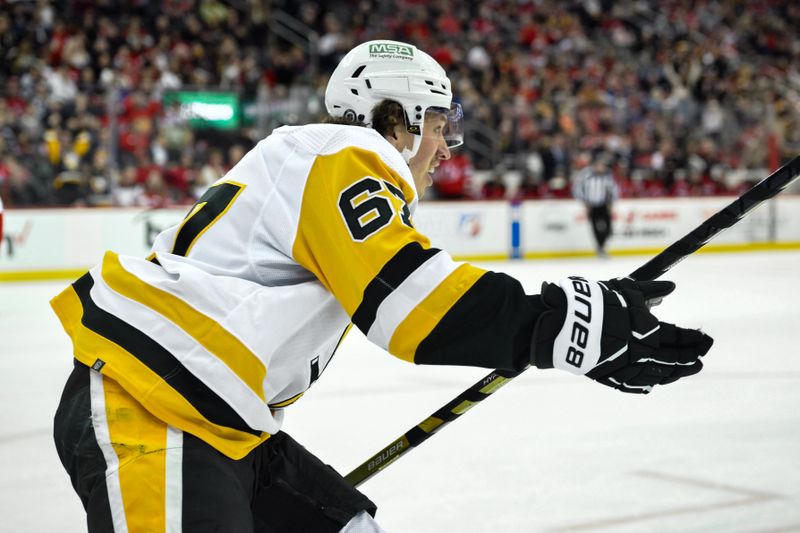 Apr 2, 2024; Newark, New Jersey, USA; Pittsburgh Penguins right wing Rickard Rakell (67) reacts after scoring a goal against the Pittsburgh Penguins during the third period at Prudential Center. Mandatory Credit: John Jones-USA TODAY Sports