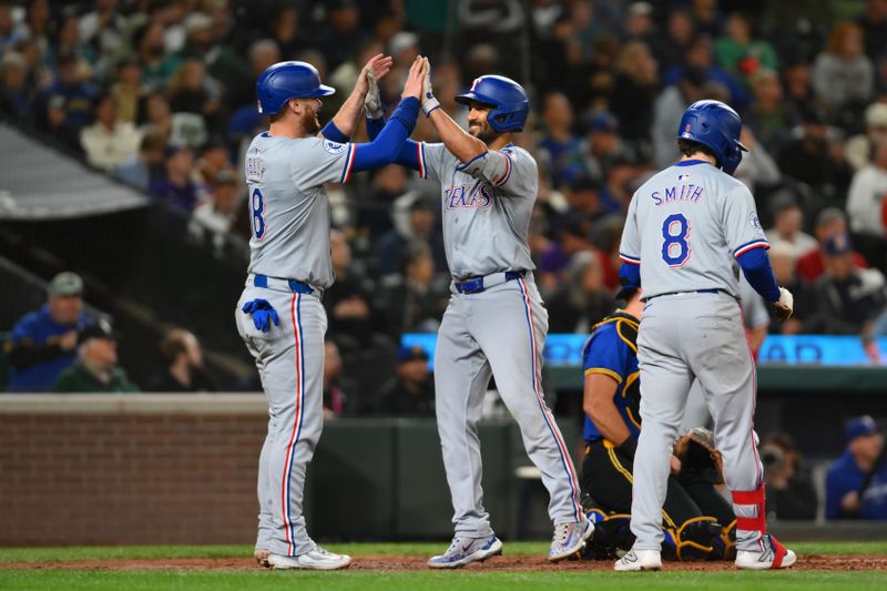 Sep 14, 2024; Seattle, Washington, USA; Texas Rangers catcher Carson Kelly (18) and second baseman Marcus Semien (2) celebrate after Semien hit a 2-run home run against the Seattle Mariners during the fifth inning at T-Mobile Park. Mandatory Credit: Steven Bisig-Imagn Images