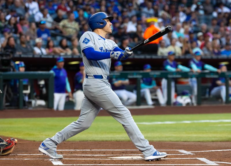 May 9, 2025; Phoenix, Arizona, USA; Los Angeles Dodgers first baseman Freddie Freeman drives in a run with a sacrifice fly in the first inning against the Arizona Diamondbacks at Chase Field. Mandatory Credit: Mark J. Rebilas-Imagn Images