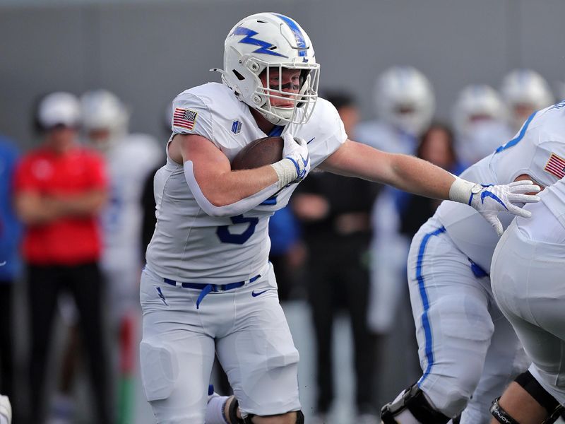 Nov 2, 2024; West Point, New York, USA; Air Force Falcons running back Dylan Carson (5) runs the ball against the Army Black Knights during the first half at Michie Stadium. Mandatory Credit: Danny Wild-Imagn Images