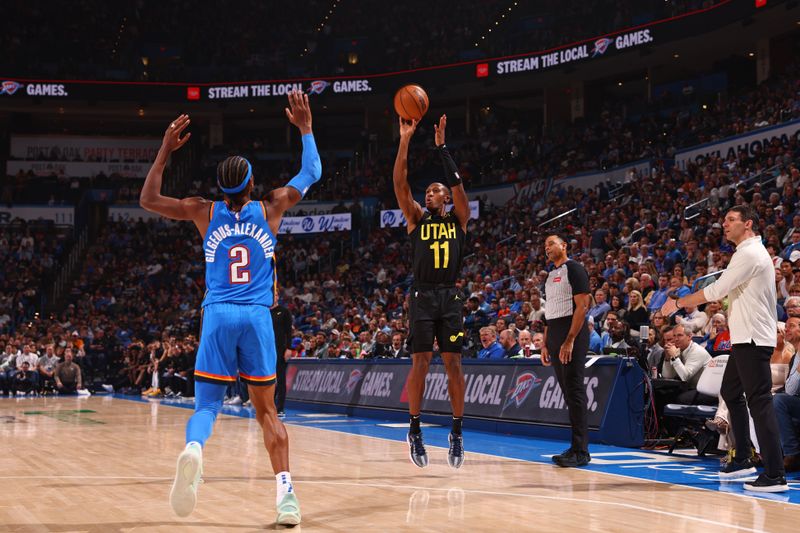 OKLAHOMA CITY, OK - MARCH 20:  Kris Dunn #11 of the Utah Jazz shoots the ball during the game against the Oklahoma City Thunder on March 20, 2024 at Paycom Arena in Oklahoma City, Oklahoma. NOTE TO USER: User expressly acknowledges and agrees that, by downloading and or using this photograph, User is consenting to the terms and conditions of the Getty Images License Agreement. Mandatory Copyright Notice: Copyright 2024 NBAE (Photo by Zach Beeker/NBAE via Getty Images)