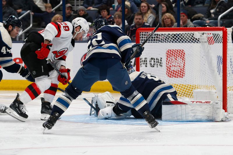 Jan 19, 2024; Columbus, Ohio, USA; Columbus Blue Jackets goalie Elvis Merzlikins (90) makes a save as New Jersey Devils right wing Timo Meier (28) looks for a rebound during the second period at Nationwide Arena. Mandatory Credit: Russell LaBounty-USA TODAY Sports