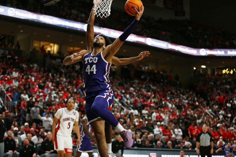 Feb 20, 2024; Lubbock, Texas, USA;  TCU Horned Frogs forward Essam Mostafa (44) goes to the basket against Texas Tech Red Raiders forward Robert Jennings (25) in the first half at United Supermarkets Arena. Mandatory Credit: Michael C. Johnson-USA TODAY Sports