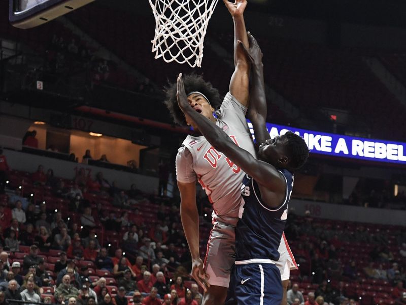 Jan 13, 2024; Las Vegas, Nevada, USA; UNLV Rebels forward Rob Whaley Jr. (5) is fouled by Utah State Aggies forward Kalifa Sakho (34) in the first half at Thomas & Mack Center. Mandatory Credit: Candice Ward-USA TODAY Sports