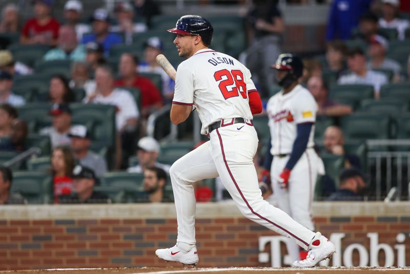 Sep 24, 2024; Atlanta, Georgia, USA; Atlanta Braves first baseman Matt Olson (28) hits a single against the New York Mets in the first inning at Truist Park. Mandatory Credit: Brett Davis-Imagn Images