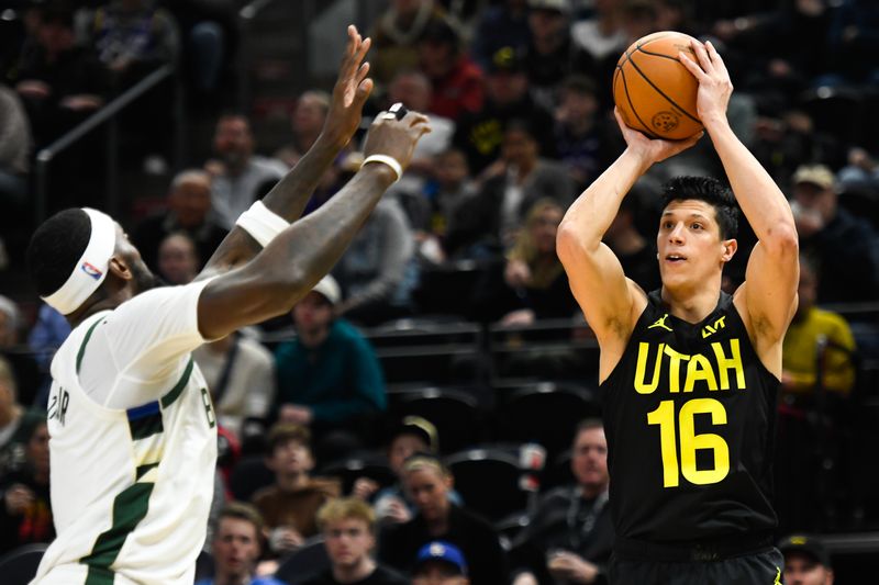 SALT LAKE CITY, UTAH - FEBRUARY 04: Simone Fontecchio #16 of the Utah Jazz shoots over Bobby Portis #9 of the Milwaukee Bucks during the second half at Delta Center on February 04, 2024 in Salt Lake City, Utah. NOTE TO USER: User expressly acknowledges and agrees that, by downloading and or using this photograph, User is consenting to the terms and conditions of the Getty Images License Agreement. (Photo by Alex Goodlett/Getty Images)