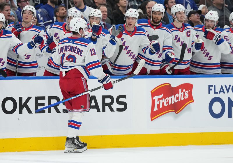 Dec 19, 2023; Toronto, Ontario, CAN; New York Rangers left wing Alexis Lafreniere (13) celebrates at the bench after scoring a goal against the Toronto Maple Leafs during the second period at Scotiabank Arena. Mandatory Credit: Nick Turchiaro-USA TODAY Sports