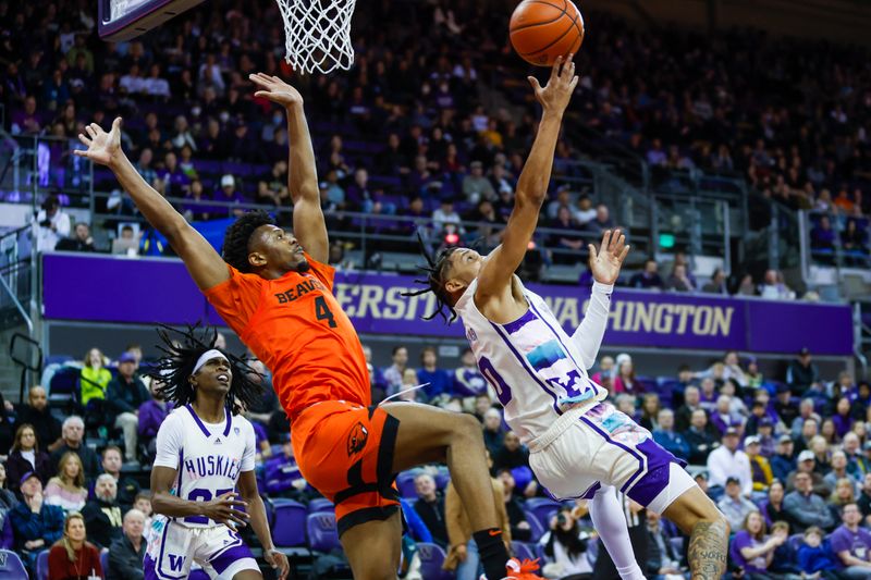 Feb 18, 2023; Seattle, Washington, USA; Washington Huskies guard Koren Johnson (0) puts up a shot following a foul by Oregon State Beavers guard Dexter Akanno (4) during the first half at Alaska Airlines Arena at Hec Edmundson Pavilion. Mandatory Credit: Joe Nicholson-USA TODAY Sports