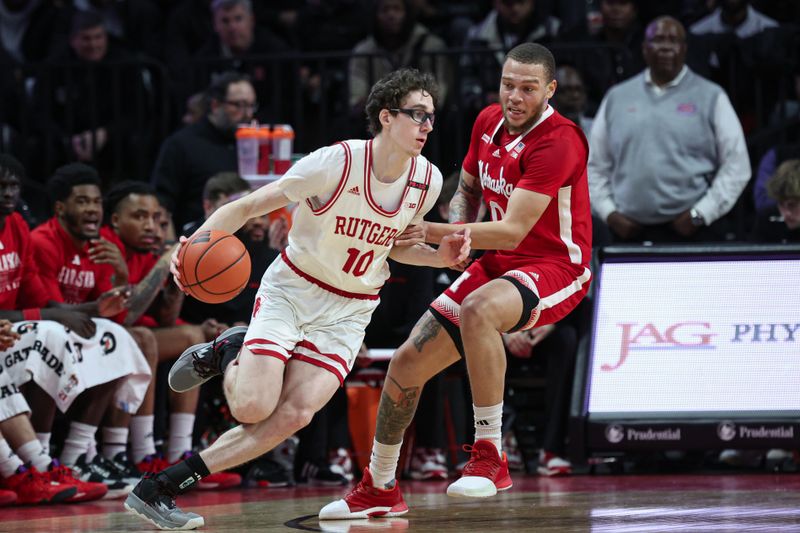 Jan 17, 2024; Piscataway, New Jersey, USA; Rutgers Scarlet Knights guard Gavin Griffiths (10) dribbles against Nebraska Cornhuskers guard C.J. Wilcher (0) during the first half at Jersey Mike's Arena. Mandatory Credit: Vincent Carchietta-USA TODAY Sports