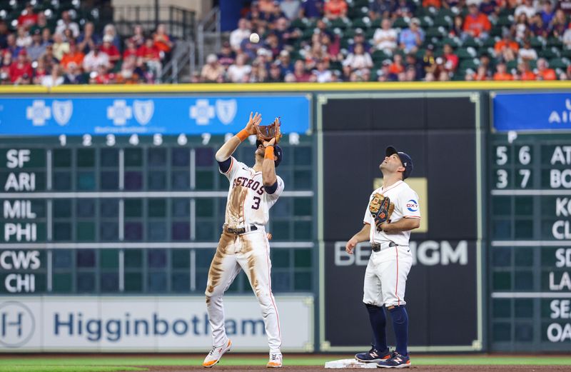 Jun 5, 2024; Houston, Texas, USA; Houston Astros second baseman Jose Altuve (27) looks on as shortstop Jeremy Pena (3) catches a pop fly during the fourth inning against the St. Louis Cardinals at Minute Maid Park. Mandatory Credit: Troy Taormina-USA TODAY Sports