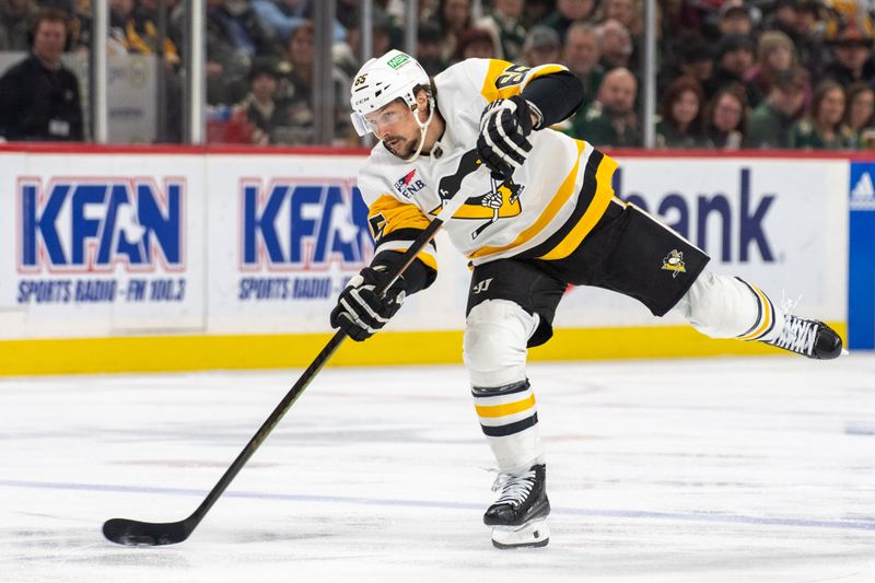 Feb 9, 2024; Saint Paul, Minnesota, USA; Pittsburgh Penguins defenseman Erik Karlsson (65) shoots against the Minnesota Wild in the first period at Xcel Energy Center. Mandatory Credit: Matt Blewett-USA TODAY Sports