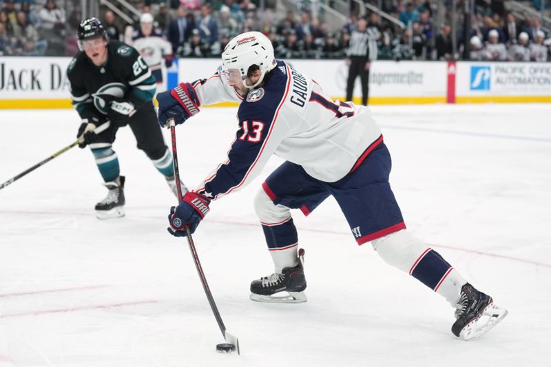 Feb 17, 2024; San Jose, California, USA; Columbus Blue Jackets left wing Johnny Gaudreau (13) shoots against the San Jose Sharks during the first period at SAP Center at San Jose. Mandatory Credit: Darren Yamashita-USA TODAY Sports