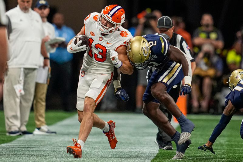 Sep 5, 2022; Atlanta, Georgia, USA; Clemson Tigers wide receiver Brannon Spector (13) is hit on the sideline by Georgia Tech Yellow Jackets linebacker Ayinde Eley (2) during the first quarter at Mercedes-Benz Stadium. Mandatory Credit: Dale Zanine-USA TODAY Sports