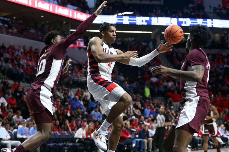 Feb 18, 2023; Oxford, Mississippi, USA; Mississippi Rebels guard Matthew Murrell (11) passes the ball as Mississippi State Bulldogs guard Dashawn Davis (10) and guard/forward Cameron Matthews (4) defends during the second half at The Sandy and John Black Pavilion at Ole Miss. Mandatory Credit: Petre Thomas-USA TODAY Sports