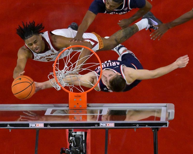 Mar 2, 2023; Los Angeles, California, USA; USC Trojans guard Reese Dixon-Waters (2) drives past Arizona Wildcats guard Cedric Henderson Jr. (45) and forward Azuolas Tubelis (10) in the second half at Galen Center. Mandatory Credit: Jayne Kamin-Oncea-USA TODAY Sports