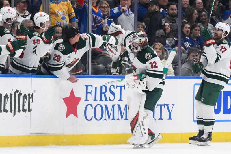 Oct 15, 2024; St. Louis, Missouri, USA; Minnesota Wild goaltender Filip Gustavsson (32) celebrates with goaltender Marc-Andre Fleury (29) after scoring a goal against the St. Louis Blues during the third period at Enterprise Center. Mandatory Credit: Jeff Le-Imagn Images