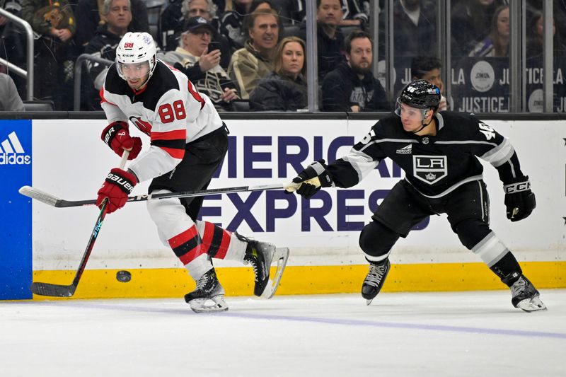 Mar 3, 2024; Los Angeles, California, USA; New Jersey Devils defenseman Kevin Bahl (88) handles the puck in front of Los Angeles Kings center Blake Lizotte (46) in the second period at Crypto.com Arena. Mandatory Credit: Jayne Kamin-Oncea-USA TODAY Sports