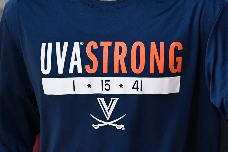 Feb 22, 2023; Chestnut Hill, Massachusetts, USA; A member of the Virginia Cavaliers men's basketball team wears a warmup jersey honoring fallen Virginia football classmates at Conte Forum. Mandatory Credit: Eric Canha-USA TODAY Sports