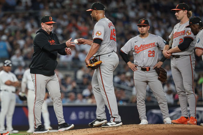 Jun 18, 2024; Bronx, New York, USA; Baltimore Orioles starting pitcher Albert Suarez (49) hands the ball to manager Brandon Hyde (18) after being relieved during the fourth inning at Yankee Stadium. Mandatory Credit: Vincent Carchietta-USA TODAY Sports