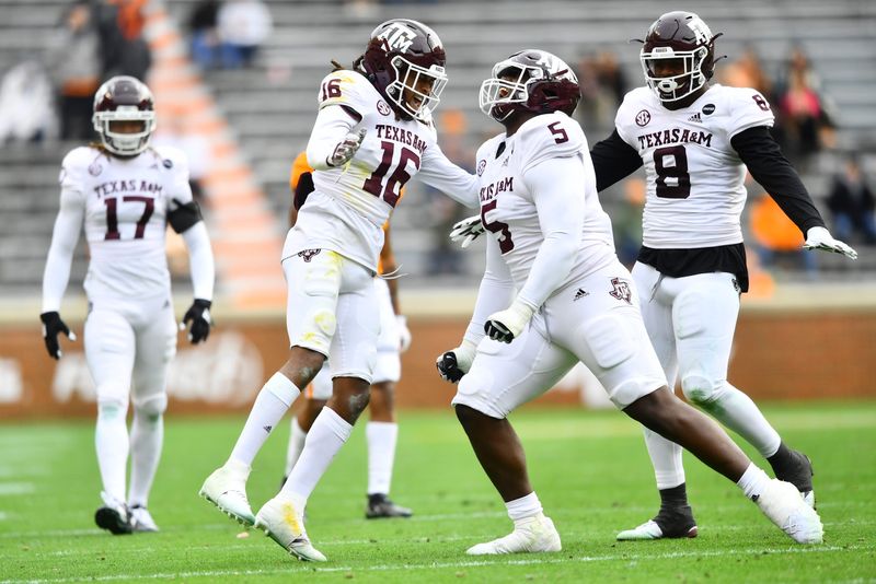 Dec 19, 2020; Knoxville, TN, USA;  Texas A&M defensive back Brian George (16), Texas A&M defenisve lineman Bobby Brown III,and Texas A&M defenisve lineman DeMarvin Leal (8) celebrate during a game between Tennessee and Texas A&M in Neyland Stadium in Knoxville, Saturday, Dec. 19, 2020. Mandatory Credit: Brianna Paciorka-USA TODAY NETWORK