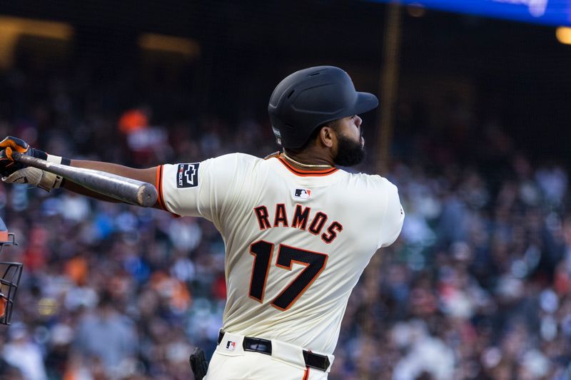 Jun 10, 2024; San Francisco, California, USA; San Francisco Giants center fielder Heliot Ramos (17) hits a single against the Houston Astros during the third inning at Oracle Park. Mandatory Credit: John Hefti-USA TODAY Sports