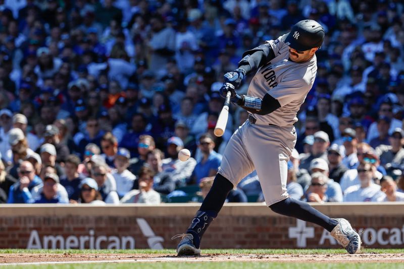 Sep 7, 2024; Chicago, Illinois, USA; New York Yankees catcher Austin Wells (28) hits an RBI-ground out against the Chicago Cubs during the first inning at Wrigley Field. Mandatory Credit: Kamil Krzaczynski-Imagn Images