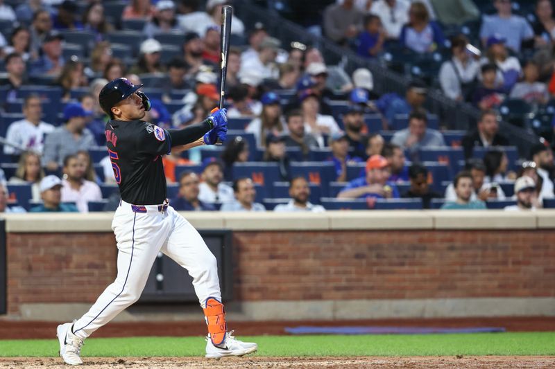 Jun 28, 2024; New York City, New York, USA;  New York Mets right fielder Tyrone Taylor (15) hits a solo home run in the fourth inning against the Houston Astros at Citi Field. Mandatory Credit: Wendell Cruz-USA TODAY Sports