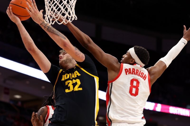 Jan 27, 2025; Columbus, Ohio, USA;  Iowa Hawkeyes forward Owen Freeman (32) shoots the ball as Ohio State Buckeyes guard Micah Parrish (8) defends during the first half at Value City Arena. Mandatory Credit: Joseph Maiorana-Imagn Images