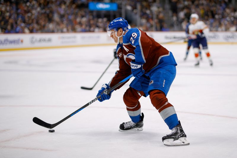Dec 11, 2025; Denver, Colorado, USA; Colorado Avalanche center Nathan MacKinnon (29) controls the puck in the second period against the Florida Panthers at Ball Arena. Mandatory Credit: Isaiah J. Downing-Imagn Images