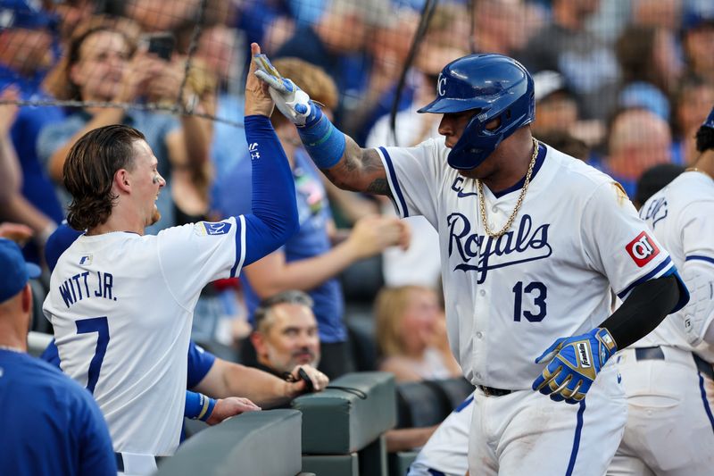 Jun 24, 2024; Kansas City, Missouri, USA; Kansas City Royals catcher Salvador Perez (13) slaps hands with Kansas City Royals shortstop Bobby Witt Jr. (7) after hitting a home run during the fourth inning against the Miami Marlins at Kauffman Stadium. Mandatory Credit: William Purnell-USA TODAY Sports