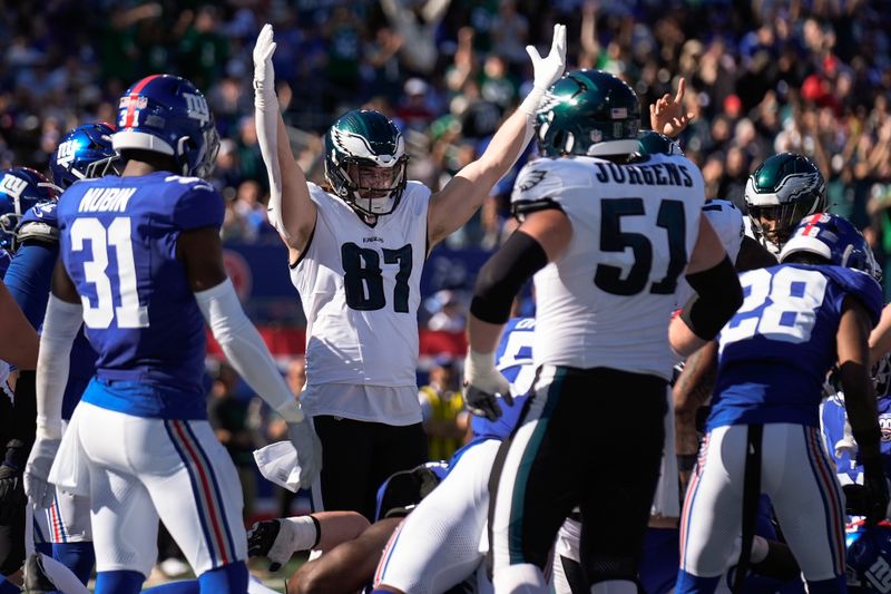 Philadelphia Eagles tight end Jack Stoll (87) motions for a touchdown after running back Saquon Barkley crossed the goal line against the New York Giants during the second quarter of an NFL football game, Sunday, Oct. 20, 2024, in East Rutherford, N.J. (AP Photo/Seth Wenig)